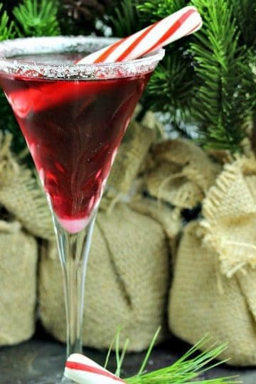 Surprise your guests by serving them a festive Pretty In Peppermint Martini! Made with Vanilla Vodka, Peppermint Schnapps and Stirrings Pomegranate Cocktail mixer, garnished with a peppermint stick! Holiday spirits never tasted so good!