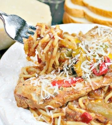 Easy Slow Cooker Tuscan Chicken is tender chicken, seasoned with peppers and Italian herbs, served on a bed of pasta!