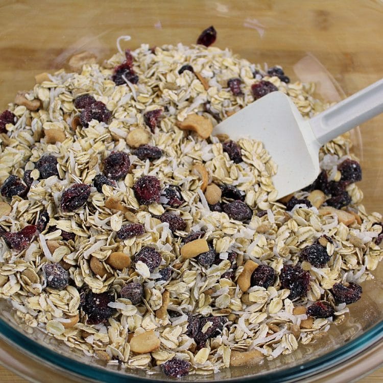 Homemade Fruit and Nut Granola could not be easier to make using this simple recipe. A healthy mix of oats, cranberries, sunflower seeds, coconut and cashews are splashed with a maple syrup mixture, then baked to crispy perfection. Great as a family-friendly breakfast and easy to customize!