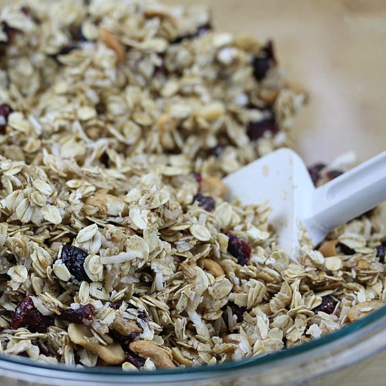 Homemade Fruit and Nut Granola could not be easier to make using this simple recipe. A healthy mix of oats, cranberries, sunflower seeds, coconut and cashews are splashed with a maple syrup mixture, then baked to crispy perfection. Great as a family-friendly breakfast and easy to customize!