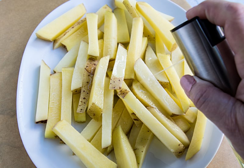 Air Fryer French Fries are a delicious way to enjoy hot and fresh fries at home. Fast and easy with little to no oil! #mustlovehomecooking