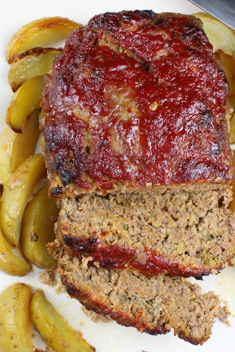 Classic Meatloaf - All seasoned and sauced up, this Southern meatloaf recipe uses celery, green onions, a bit of garlic and chili sauce for incredible flavor. This no-fail, kid approved recipe is sure to become a family favorite.