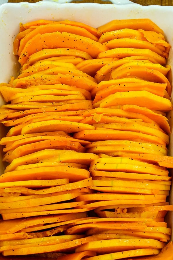 Sliced squash in white baking pan