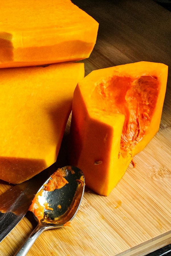 chunks of raw squash with chefs knife and spoon