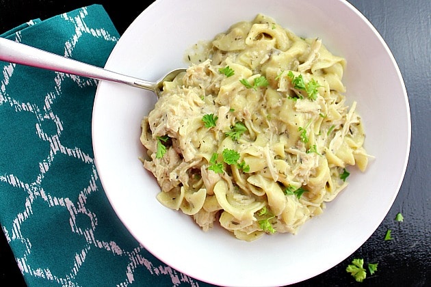 Slow Cooker Herb Chicken Noodles recipe is a hearty meal with shredded chicken, egg noodles, and herbs like thyme and parsley.