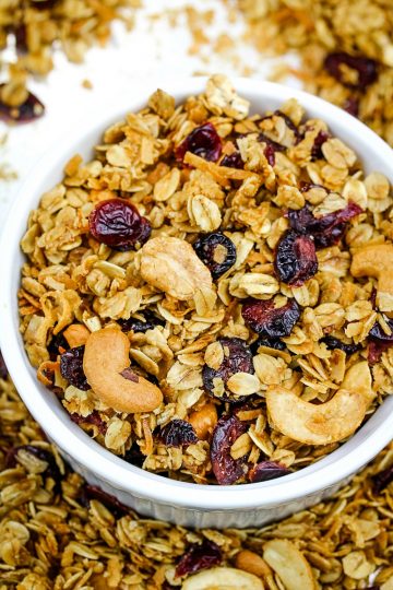 Homemade Fruit and Nut Granola is a healthy mix of oats, cranberries, sunflower seeds, coconut and cashews splashed with a maple syrup mixture, then baked to crispy perfection. Great as a family-friendly breakfast or snack and easy to customize!