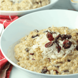 This hearty Slow Cooker Cranberry Coconut Oatmeal is made with lots of creamy coconut milk, steel cut oats, chewy dried cranberries, brown sugar and pie spice. Top off each bowlful with a handful of cranberries and coconut followed by a splash of coconut milk. A true breakfast of champions!