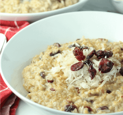This hearty Slow Cooker Cranberry Coconut Oatmeal is made with lots of creamy coconut milk, steel cut oats, chewy dried cranberries, brown sugar and pie spice. Top off each bowlful with a handful of cranberries and coconut followed by a splash of coconut milk. A true breakfast of champions!