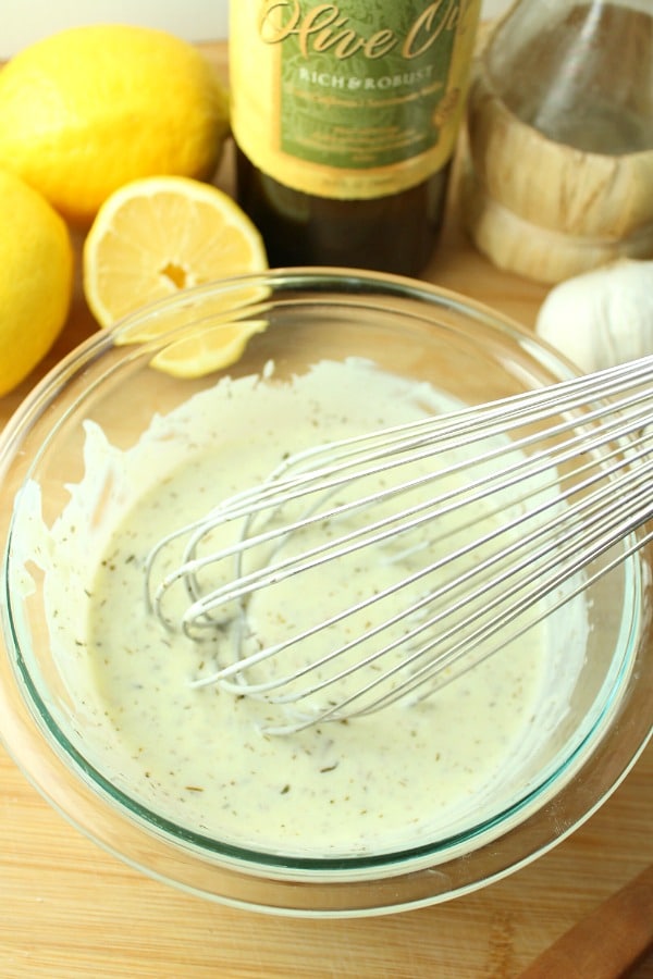 creamy herb greek yogurt dressing being mixed