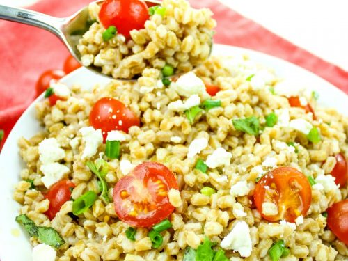 Greek Farro Tomato Salad with Feta Cheese is packed with nutty flavor, protein and nutrients. Ready in just 20 minutes, this versatile salad is a perfect pairing for any meal.