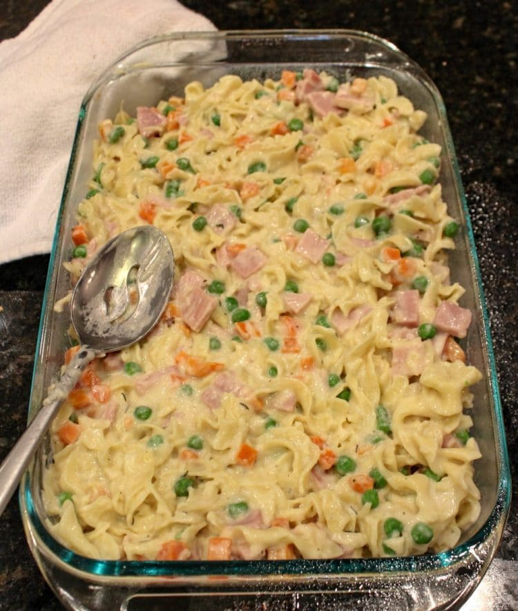 Smoked Ham Peas and Carrots Bake ready to go into the oven in a glass pan