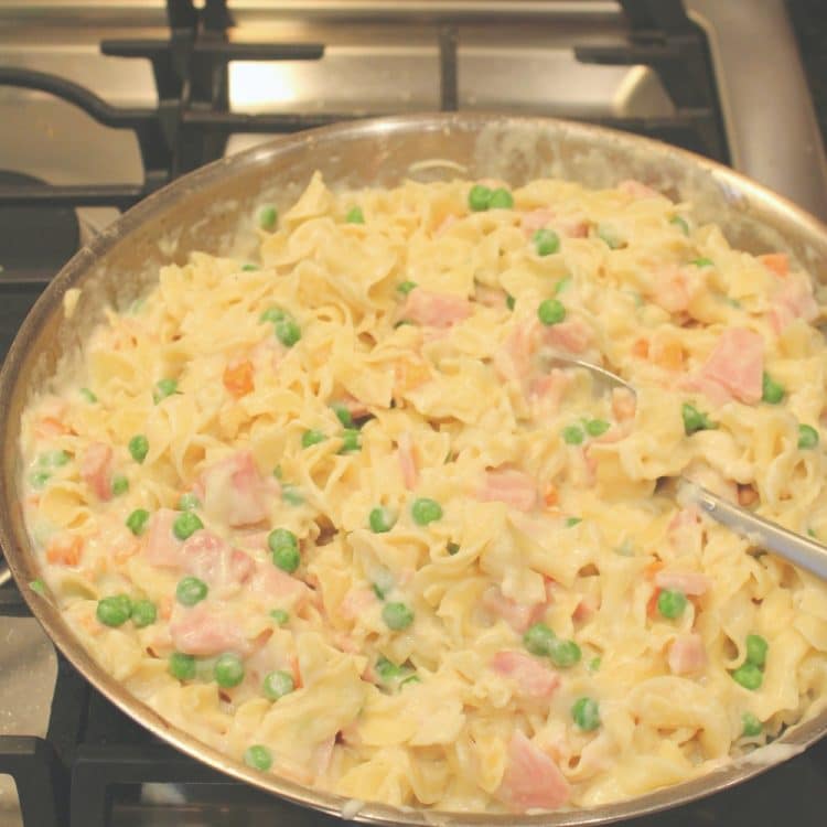 Smoked Ham Peas and Carrots Bake in a pan on the stove