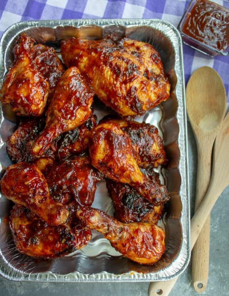 Best barbecue Cookout Chicken in a pan with wooden sppons and dipping sauce