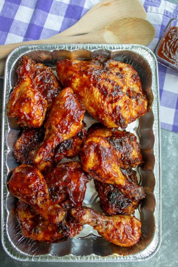 Best barbecue Cookout Chicken in a pan with wooden sppons and dipping sauce