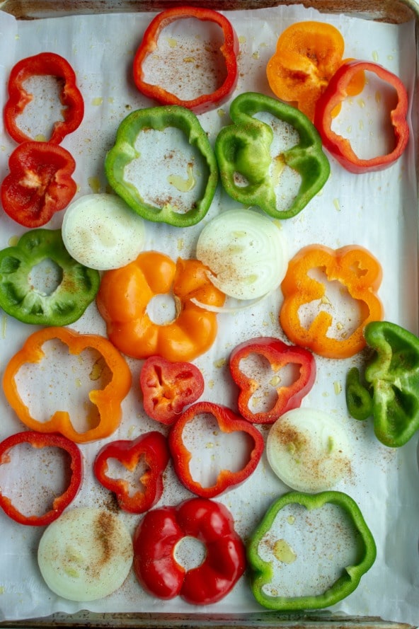 sliced sweet peppers on sheet pan