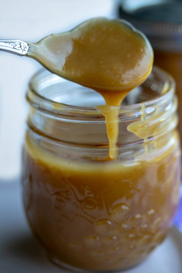 peanut butter sundae sauce on a spoon in a jar