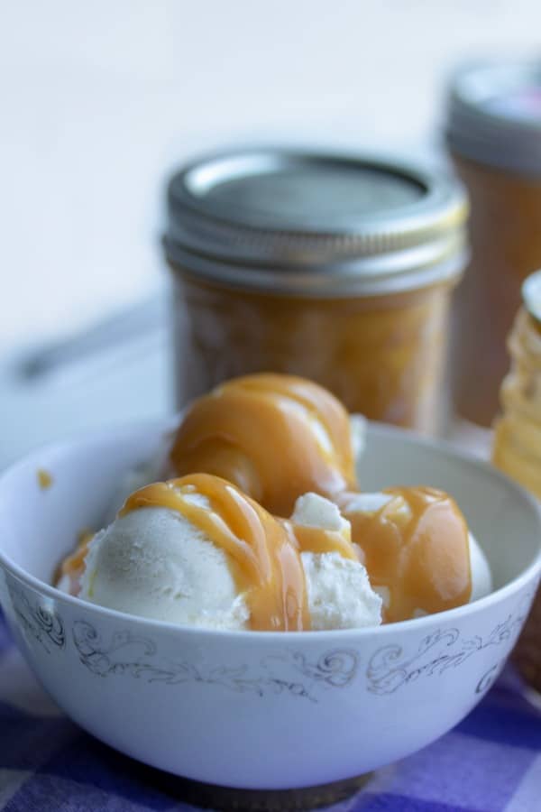 Peanut Butter Sundae Sauce on vanilla ice cream in a white bowl