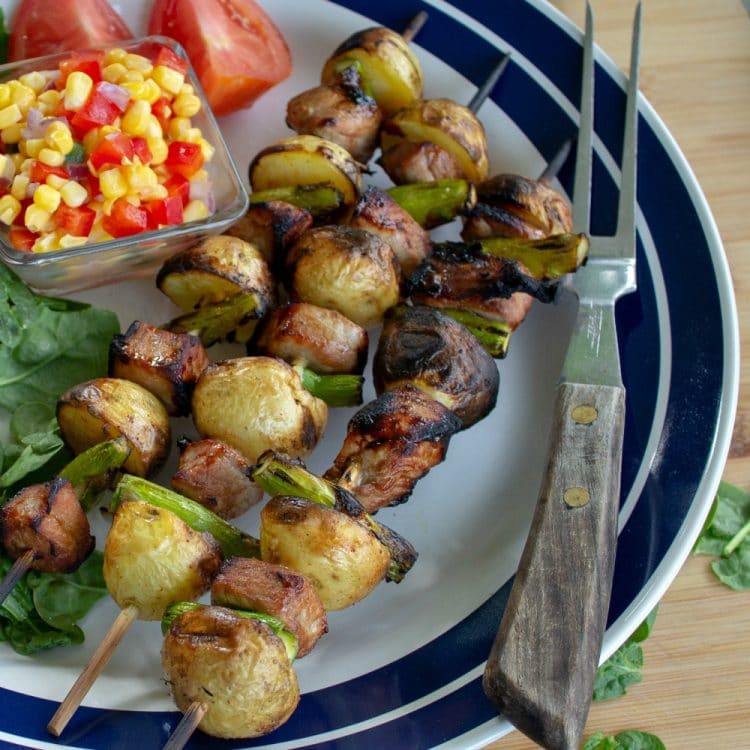 Grilled Marinated Pork Potato Shish Kebab on white platter