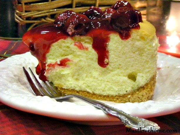 Tall New York Cheesecake, baked high and light with fruit topping, is a melt in your mouth dessert that will look beautiful on any holiday dessert table!