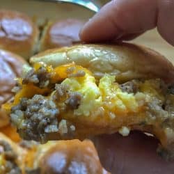 egg sausage breakfast slider held in hand