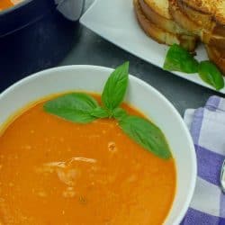 Roasted Tomato Soup - fresh, smooth and full of incredibly concentrated flavor from sheet-pan roasting the tomatoes, vegetables and garlic. This recipe is great for using up your garden tomatoes and veggies, and can be made ahead too!