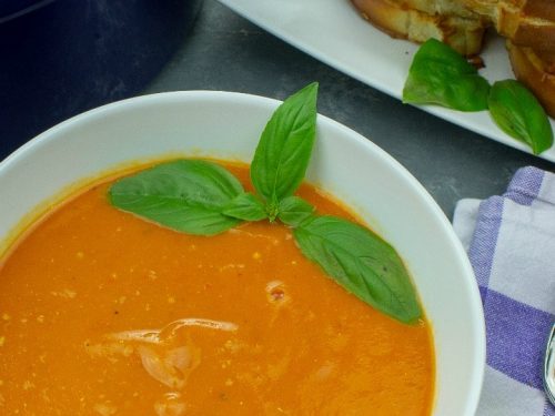 Roasted Tomato Soup - fresh, smooth and full of incredibly concentrated flavor from sheet-pan roasting the tomatoes, vegetables and garlic. This recipe is great for using up your garden tomatoes and veggies, and can be made ahead too!