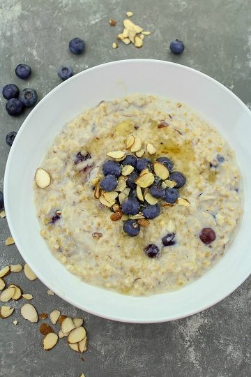 Slow Cooker Blueberry Almond Oatmeal is made with lots of healthy milk, steel cut oats, fresh blueberries, brown sugar and cinnamon topped with a handful of healthy blueberries and