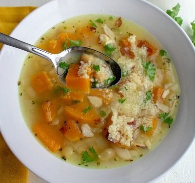Savory Butternut Squash Bean Soup is a savory protein-packed blend of butternut squash, white beans, chickpeas and couscous. Warm, comforting and so tasty this will be a favorite family soup.