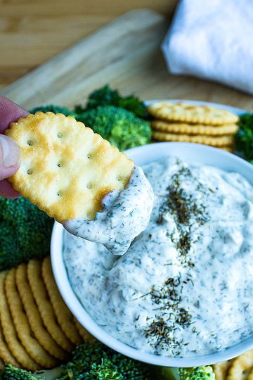 Simple and refreshing, this creamy dill dip is party ready in just minutes. Dill dip is perfect served with your favorite chips, crackers and fresh chopped veggies! #mustlovehomecooking