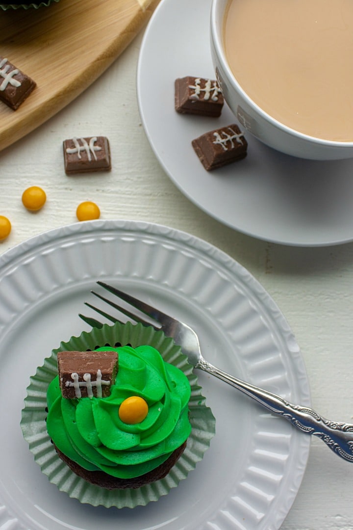 Easy Candy Football Cupcakes are chocolate cake, topped with rich buttercream frosting. Decorated with candies, these cupcakes are perfect for game day parties and tailgating!