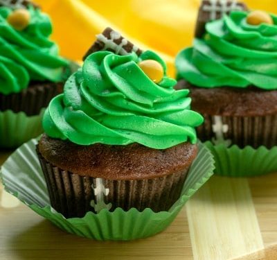 Easy Candy Football Cupcakes are chocolate cake, topped with rich buttercream frosting. Decorated with candies, these cupcakes are perfect for game day parties and tailgating!