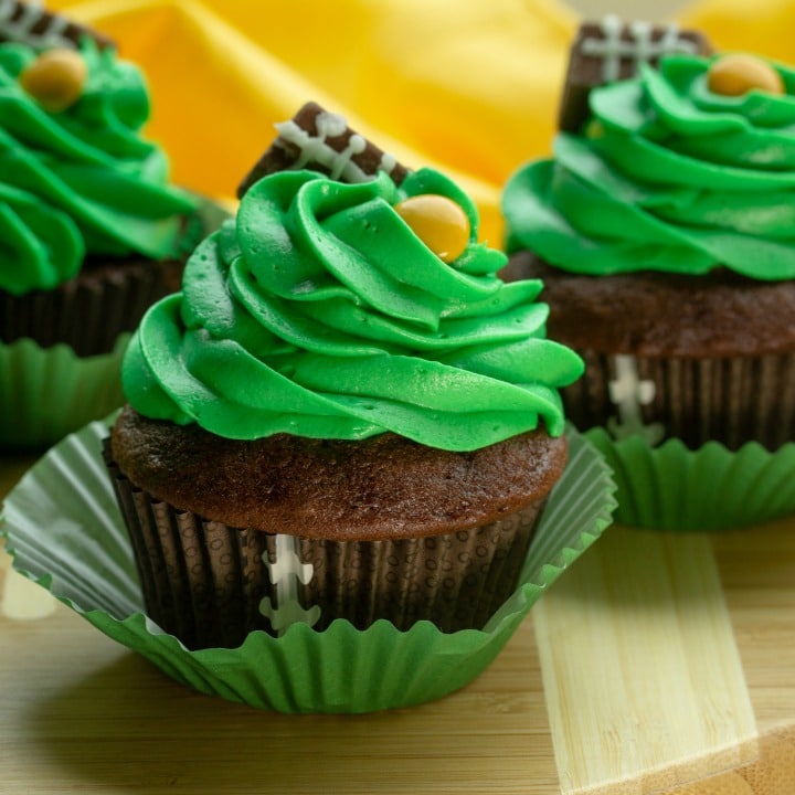 Easy Candy Football Cupcakes are chocolate cake, topped with rich buttercream frosting. Decorated with candies, these cupcakes are perfect for game day parties and tailgating!