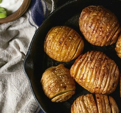baked hasselback potatoes in cast iron skillet