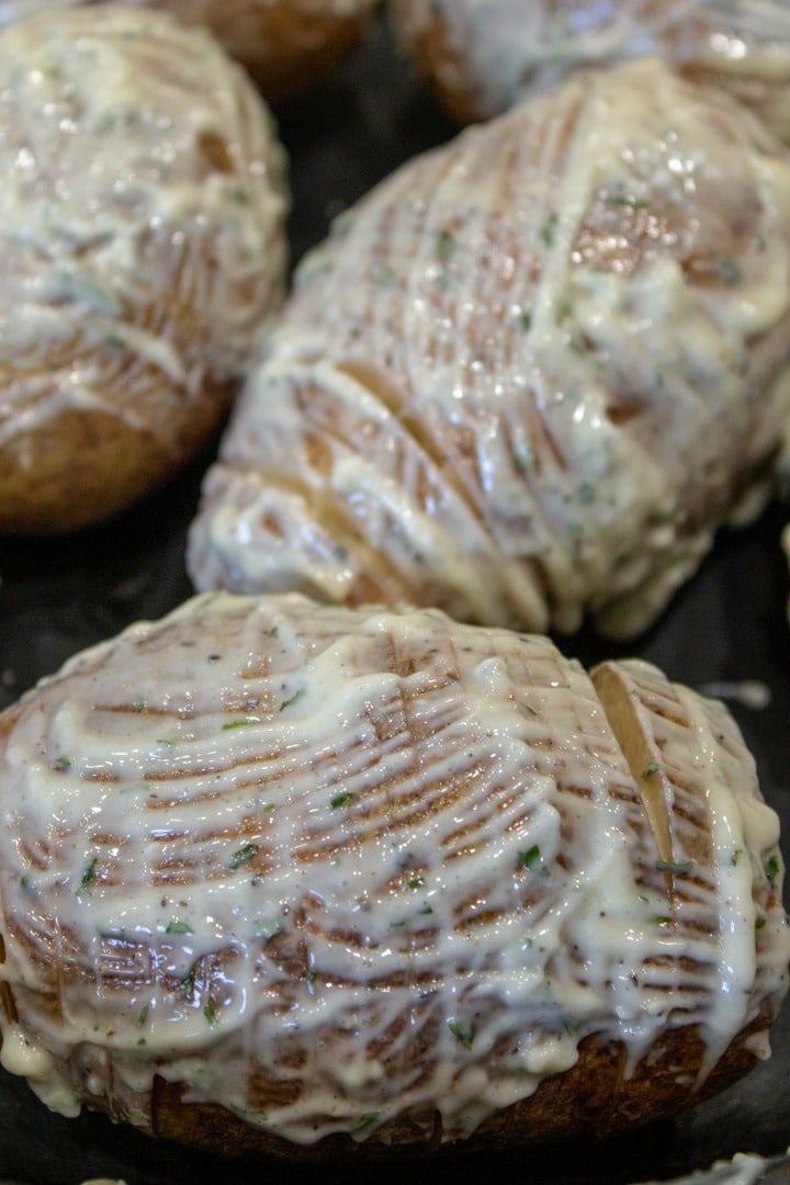 hasselback potatoes coated with butter and herbs