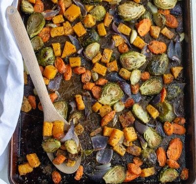 roasted vegetables on a pan with parmesan olive oil and garlic