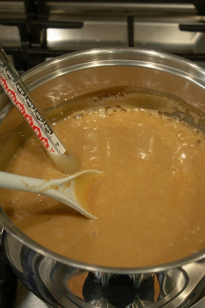 salted chewy caramels boiling with a candy thermometer