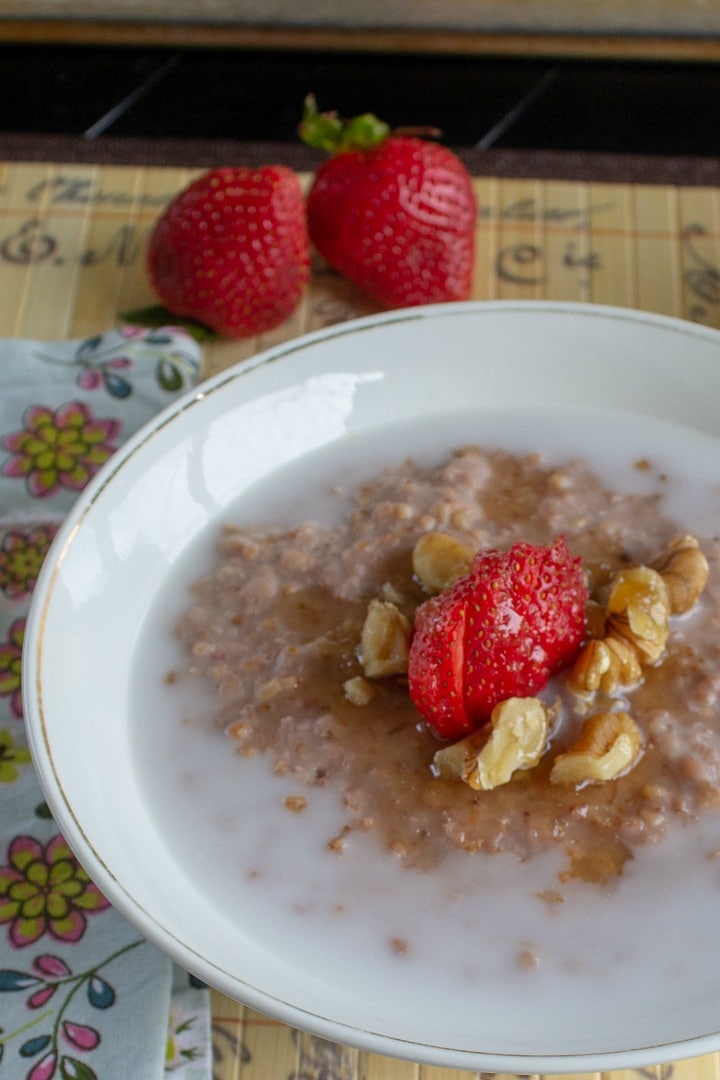 Breakfast is ready with Easy Slow Cooker Strawberry Honey Oatmeal. Steel cut oats, fresh strawberries and raw honey  are slow cooked into  a smooth and creamy bowlful of delicious. Make ahead for the entire week!