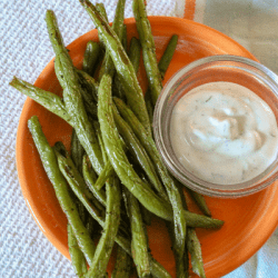 Zesty Green Bean Dippers are oven roasted, spicy green beans roasted in the oven until crispy, served with fat-free dill dip! Only 38 calories a serving, including dip!