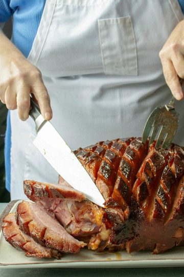 Brown Sugar Rum Baked Ham, with crispy brown edges and sticky glaze, will be the centerpiece of your Sunday or holiday dinner table.