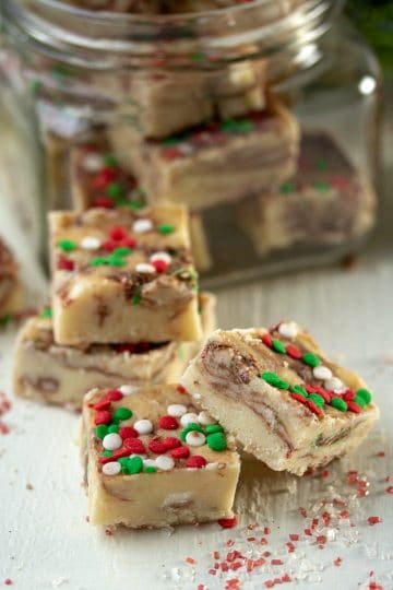 A sweet Holiday Cake Mix Fudge made with white cake mix and marbled with chocolate candies! A great cookie alternative that is perfect for gift-giving!