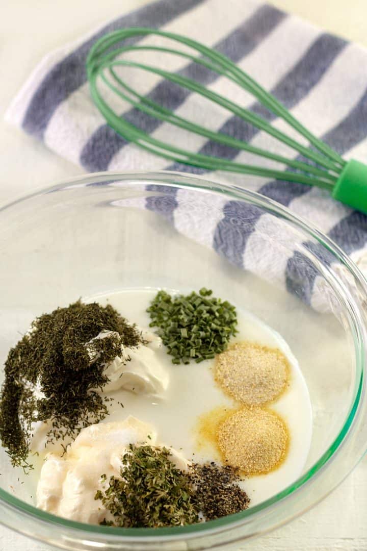 Buttermilk Ranch dressing ingredients in a glass mixing bowl