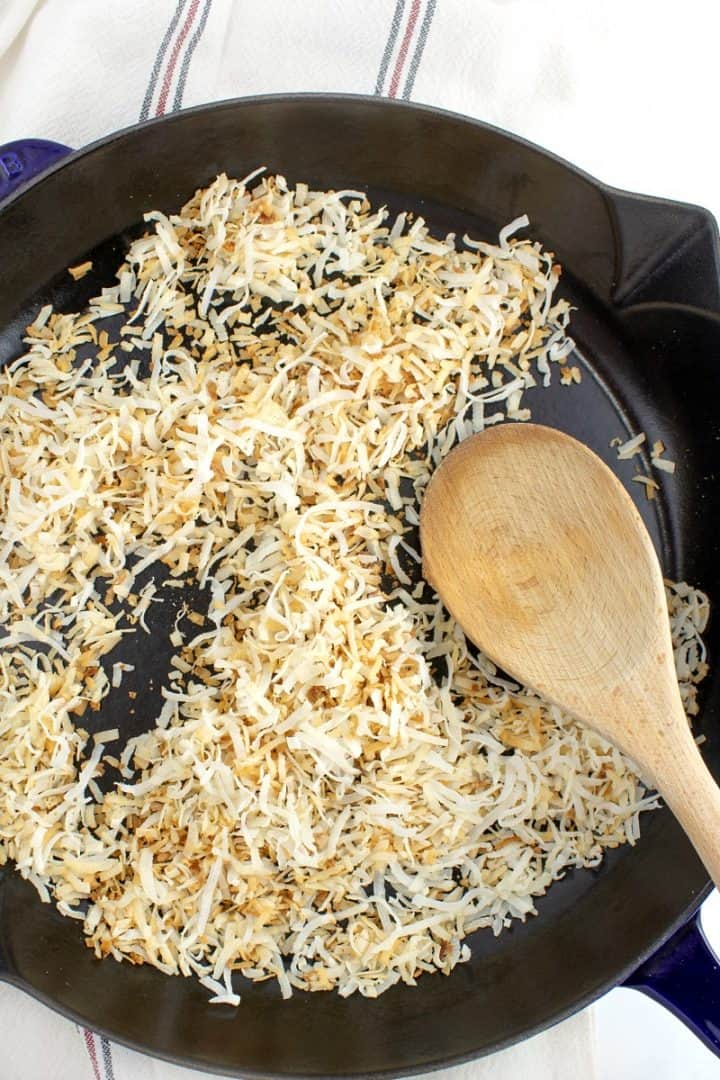 Shredded coconut toasting in a skillet