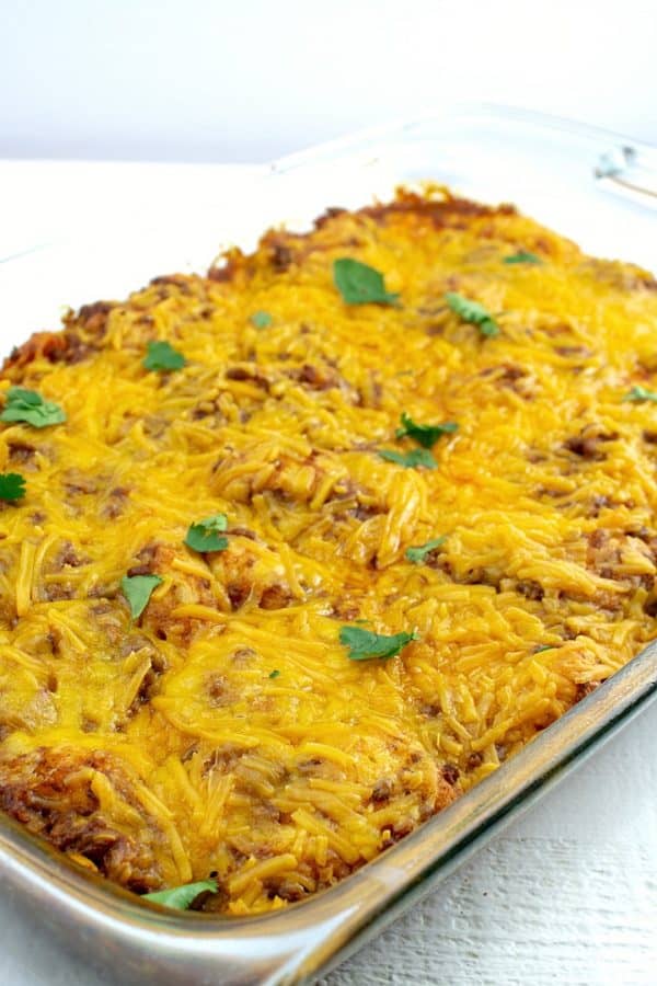 Soft and chewy, filled with spicy ground beef and oozing with cheese, this Taco Biscuit Casserole is an amazing addition to the taco night lineup!