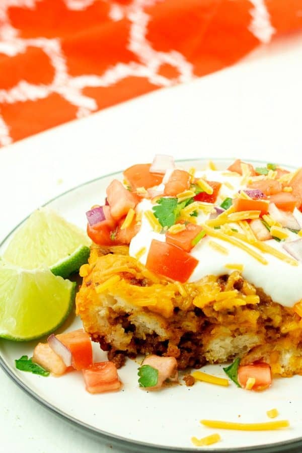 Soft and chewy, filled with spicy ground beef and oozing with cheese, this Taco Biscuit Casserole is an amazing addition to the taco night lineup!