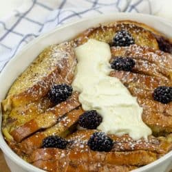 Blackberry Cream French Toast smothered with cream sauce and fresh balcberries