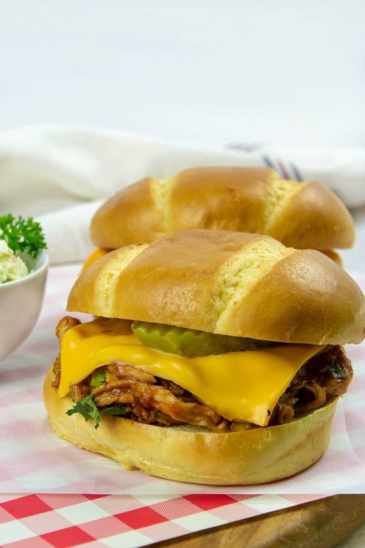 Super easy with crockpot or rotisserie chicken, these shredded BBQ Chicken Sliders will be ready in a hurry!