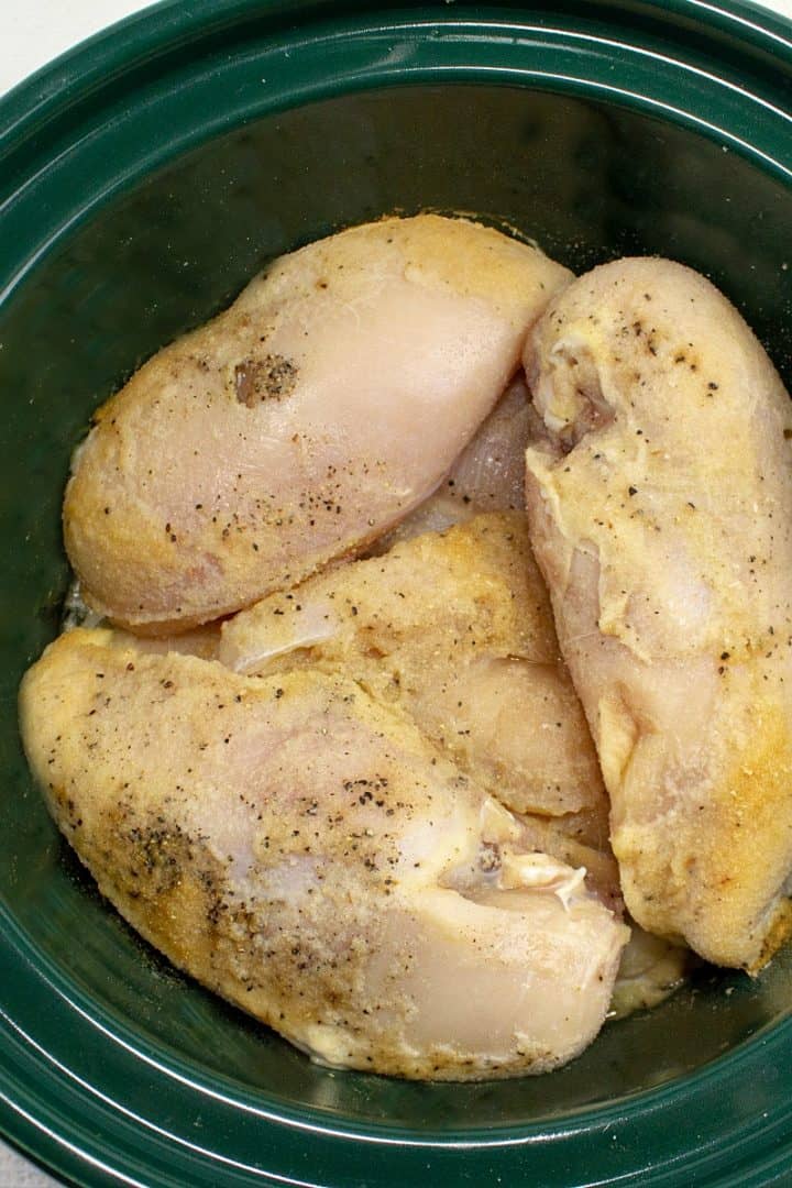 Raw chicken breasts in slow cooker