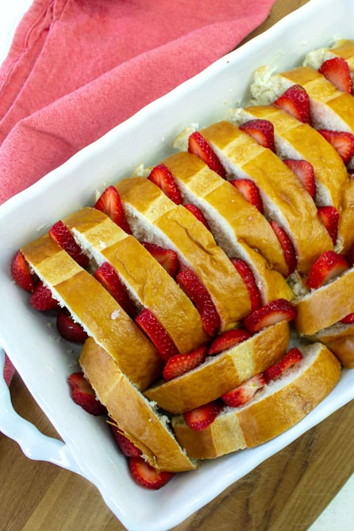 bread slices and strawberries in baking pan