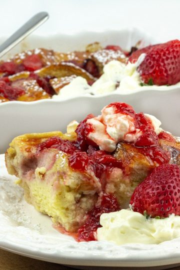 french toast with whipped cream and strawberry syrup