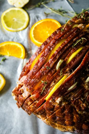 Citrus Stuffed Spiral Ham -Citrus slices, garlic and herbs steam in flavor as this holiday favorite bakes!